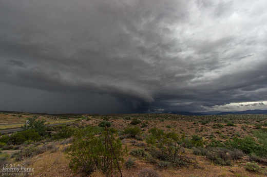 A kink in the gust front develops, leading to a conical lowering. View is to the north from Highway 93. 8:40 AM / 1540Z