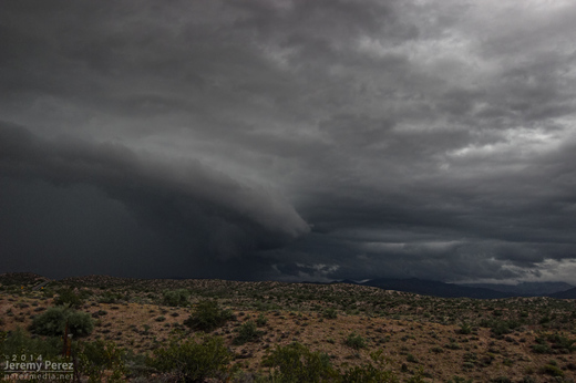 A kink in the gust front develops, leading to a conical lowering. View is to the north from Highway 93. 8:40 AM / 1540Z