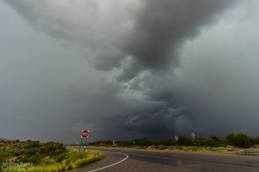 A dark rain free base peeks out from between two rain cores as seen from Highway 93 looking southwest. 9:50 AM / 1650Z