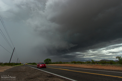 RFD partially obscures the rotating wall cloud on a receding supercell between Wickenburg and Congress. As seen from Highway 89 looking north-northeast. 11:35 AM / 1835Z